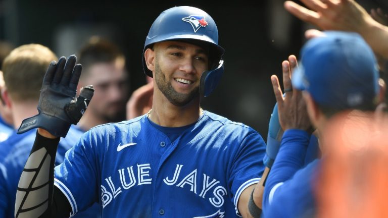 Toronto Blue Jays' Lourdes Gurriel Jr. is congratulated after scoring on a double by Breyvic Valera in the third inning of a baseball game against the Baltimore Orioles Sunday, Sept. 12, 2021, in Baltimore. The Blue Jays won 22-7 (Gail Burton/AP).