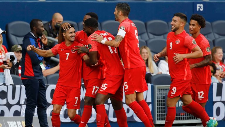 Canada midfielder Stephen Eustaquio (7) is congratulated by teammates after scoring on a penalty kick. (Colin E. Braley/AP)