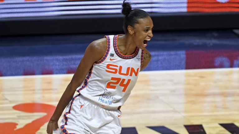 Connecticut Sun forward DeWanna Bonner celebrates after scoring on a fast break give-and-go exchange with Jasmine Thomas against the Chicago Sky during a WNBA basketball game. (Sean D. Elliot/The Day via AP)