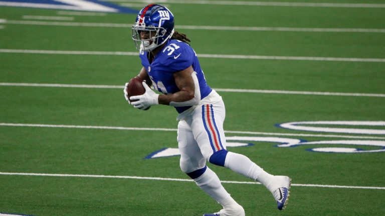 New York Giants running back Devonta Freeman (31) carries the ball against the Dallas Cowboys in the first half of an NFL football game in Arlington, Texas, Sunday, Oct. 11, 2020 (Michael Ainsworth/AP).