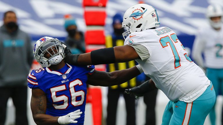 Buffalo Bills defensive end Mike Love (56) is blocked by Miami Dolphins offensive tackle Austin Jackson (73) in the first half of an NFL football game. (John Munson/AP)
