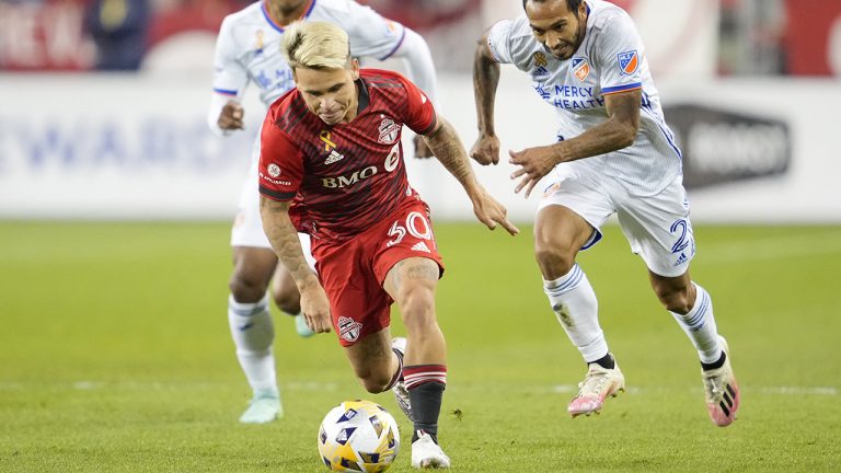 Toronto FC's Yeferson Soteldo carries the ball past FC Cincinnati's Edgar Castillo during the first half of MLS soccer action in Toronto. (Mark Blinch/CP)