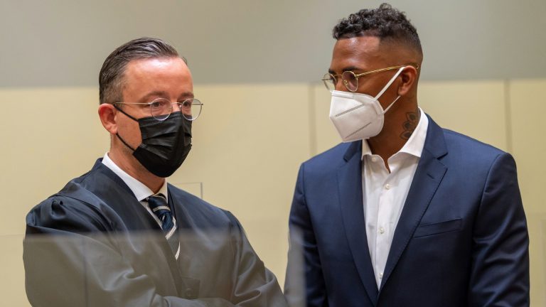 Professional footballer and former national player Jerome Boateng, right, stands with his lawyer Kai Walden, left, at the beginning of the trial against him at the District Court in Munich, Germany, Thursday, Sept. 9, 2021. Boateng is being tried on charges of assault. (Peter Kneffel/dpa via AP)
