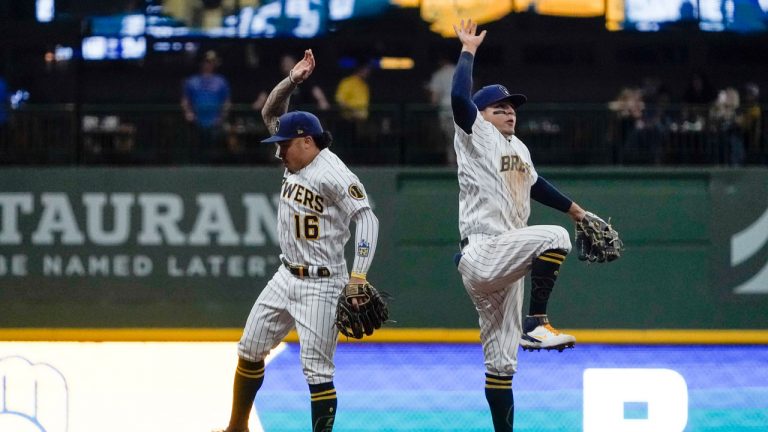 Milwaukee Brewers' Kolten Wong and Luis Urias celebrate after a baseball game against the Chicago Cubs. (Morry Gash/AP) 