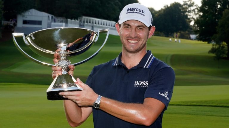Patrick Cantlay poses with the trophy after winning the Tour Championship golf tournament and the FedEx Cup at East Lake Golf Club, Sunday, Sept. 5, 2021, in Atlanta. (Brynn Anderson/AP)