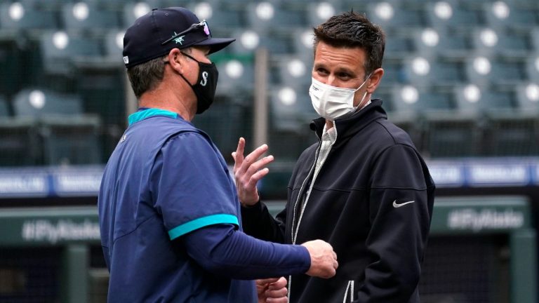 Seattle Mariners general manager Jerry Dipoto, right, talks with manager Scott Servais before the team's baseball game against the San Francisco Giants on Thursday, April 1, 2021, in Seattle. (Elaine Thompson/AP)