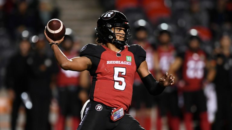 Ottawa Redblacks quarterback Caleb Evans (5) throws the ball against the Edmonton Elks during first half CFL football action in Ottawa on Tuesday, Sept. 28, 2021. (Justin Tang/The Canadian Press)