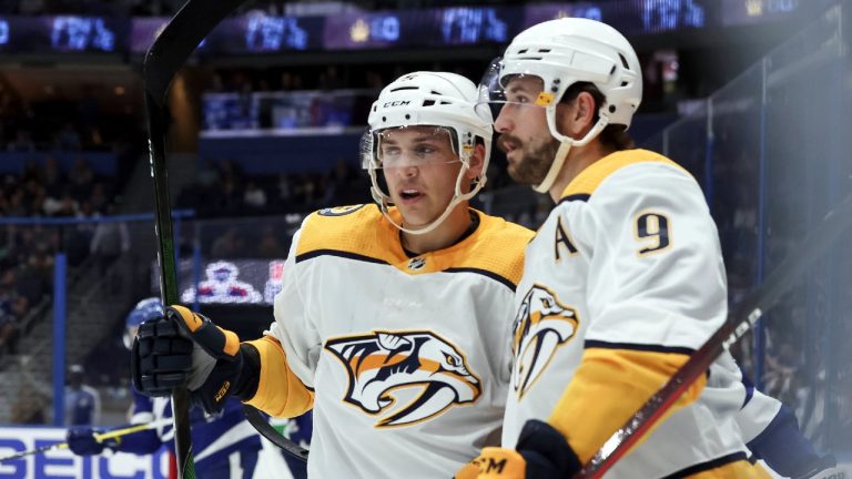 Nashville Predators' Filip Forsberg (9) celebrates his goal against the Tampa Bay Lightning with Matt Benning (5) during the first period of a preseason NHL hockey game Thursday, Sept. 30, 2021, in Tampa, Fla. (Mike Carlson/AP)