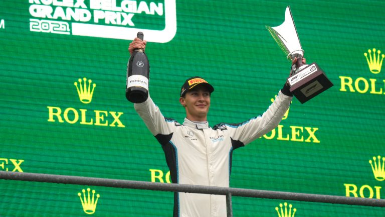 Second place Williams driver George Russell of Britain holds his trophy on the podium after the Formula One Grand Prix at the Spa-Francorchamps racetrack in Spa, Belgium, Sunday, Aug. 29, 2021. The race was red flagged due to weather conditions. (Francisco Seco/AP) 
