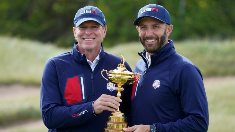 Team USA captain Steve Stricker and Team USA's Dustin Johnson hold the Ryder Cup during a practice day at the Ryder Cup at the Whistling Straits Golf Course Wednesday, Sept. 22, 2021, in Sheboygan, Wis. (Charlie Neibergall/AP)