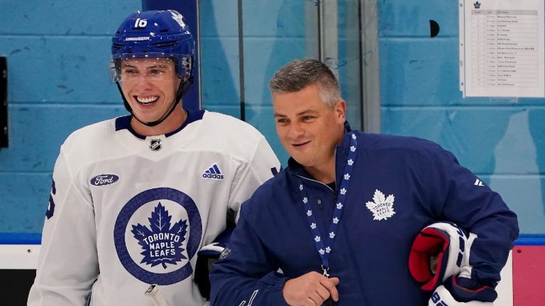 Toronto Maple Leafs forward Mitch Marner, left, laughs with Maple Leafs head coach Sheldon Keefe during their NHL training camp in Toronto on Thursday, September 23, 2021. (Nathan Denette/CP)