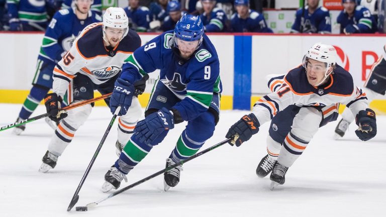 Vancouver Canucks' J.T. Miller (9) skates around Edmonton Oilers' Ryan McLeod (71) and scores a goal during the second period of an NHL hockey game in Vancouver, B.C., Monday, May 3, 2021. (Darryl Dyck/CP)