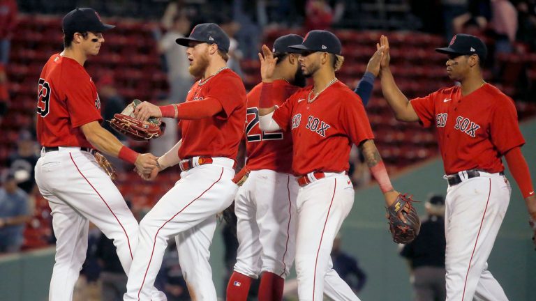 Boston Red Sox players celebrate after beating the Cleveland Indians in a baseball game at Fenway Park. (Mary Schwalm/AP)