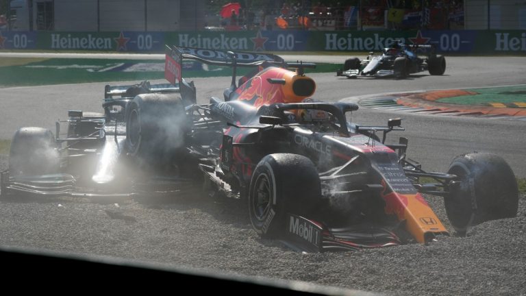 Red Bull driver Max Verstappen of the Netherlands, right and Mercedes driver Lewis Hamilton of Britain crash during the Italian Formula One Grand Prix, at Monza racetrack, in Monza, Italy, Sunday, Sept.12, 2021. (Luca Bruno/AP)