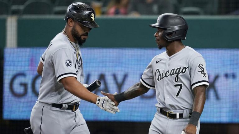 Chicago White Sox's Jose Abreu, left, and Tim Anderson celebrate after Anderson scored on a sacrifice fly by Abreu during the first inning of the team's baseball game against the Texas Rangers. (Tony Gutierrez/AP)