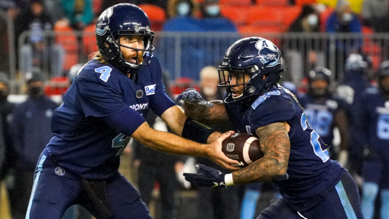 Toronto Argonauts QB McLeod Bethel-Thompson hands off the ball to running back D.J. Foster in Saturday's CFL action. (CP)