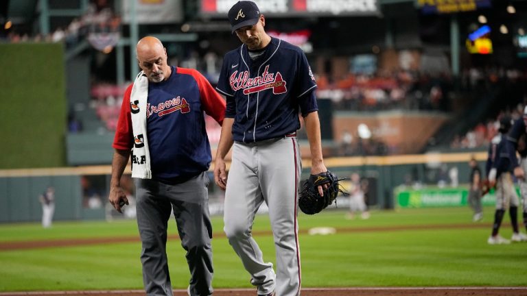 Atlanta Braves starting pitcher Charlie Morton is helped off the field during the third inning of Game 1 in baseball's World Series between the Houston Astros and the Atlanta Braves Tuesday, Oct. 26, 2021, in Houston (Ashley Landis/AP).