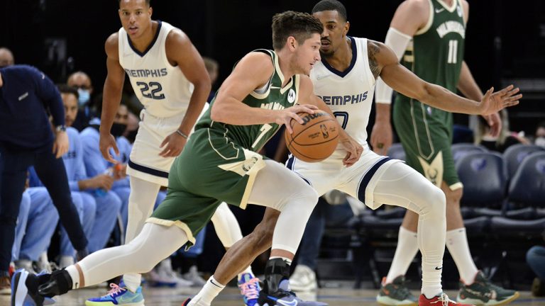 Milwaukee Bucks guard Grayson Allen (3) drives against Memphis Grizzlies guard De'Anthony Melton (0) in the first half of an NBA preseason basketball game Tuesday, Oct. 5, 2021, in Memphis, Tenn. (Brandon Dill/AP)