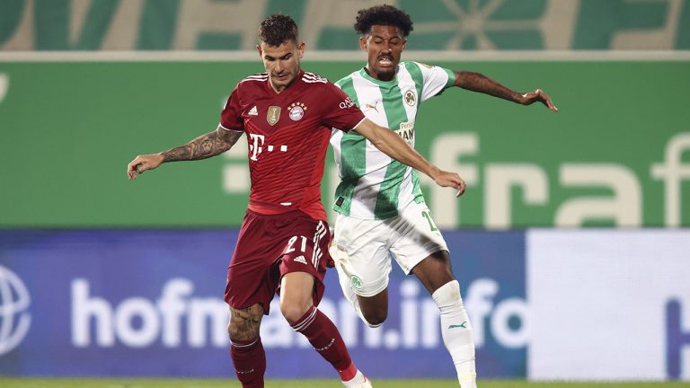 Bayern's Lucas Hernandez, left, and Furth's Jeremy Dudziak battle for the ball during the Bundesliga soccer match between SpVgg Greuther Furth and Bayern Munich. (Daniel Karmann/dpa via AP)