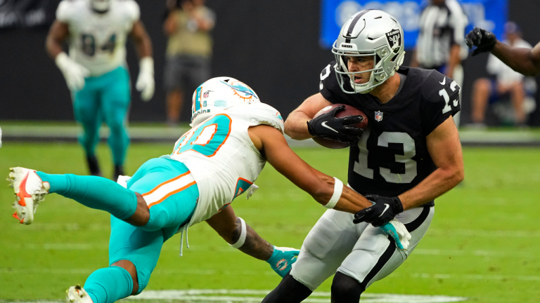 Miami Dolphins defensive back Nik Needham (40) attempts to tackle Las Vegas Raiders wide receiver Hunter Renfrow (13) during the first half of an NFL football game, Sunday, Sept. 26, 2021, in Las Vegas. (Rick Scuteri/AP)