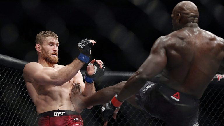 Jared Cannonier, right, connects with a kick to body of Jan Blachowicz in preliminary light heavyweight bout action at the UFC Fight Night - Lawler vs Dos Anjos event in Winnipeg. (John Woods/CP)