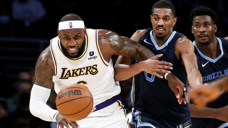 Los Angeles Lakers forward LeBron James, left, and Memphis Grizzlies guard De'Anthony Melton chase the ball during the second half of an NBA basketball game. (Ringo H.W. Chiu/AP)