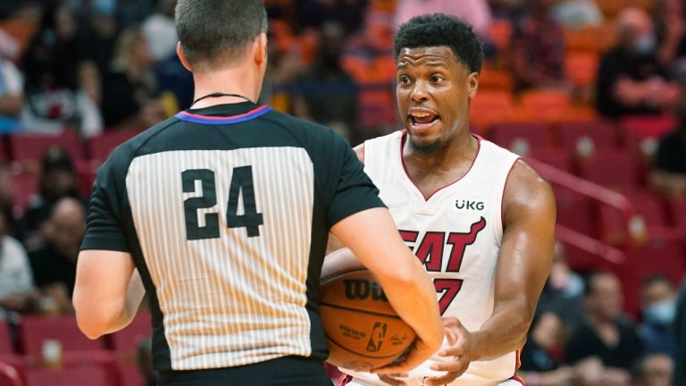 Miami Heat guard Kyle Lowry (7) argues a call with referee Kevin Scott (24) during the first half of an NBA basketball game against the Orlando Magic, Monday, Oct. 25, 2021, in Miami. (AP Photo/Marta Lavandier) 