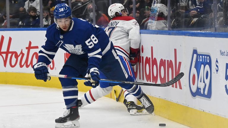 Toronto Maple Leafs' Michael Bunting (58) takes possession of the puck from Montreal Canadiens’ Alexander Romanov during the first period of their NHL preseason hockey game. (Jon Blacker/CP)