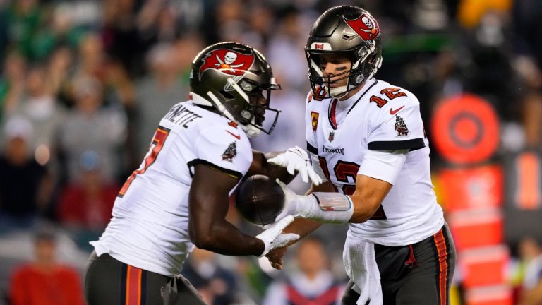 Tampa Bay Buccaneers quarterback Tom Brady (12) hands the ball off to Tampa Bay Buccaneers running back Leonard Fournette (7) during the first half of an NFL football game against the Philadelphia Eagles, Thursday, Oct. 14, 2021, in Philadelphia (Matt Slocum/AP).