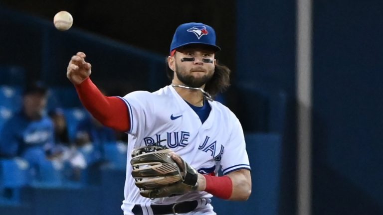 Toronto Blue Jays' Bo Bichette throws to first base to put out Baltimore Orioles Trey Mancini in the first inning of an American League baseball game in Toronto on Friday, Oct. 1, 2021. (Jon Blacker/CP)