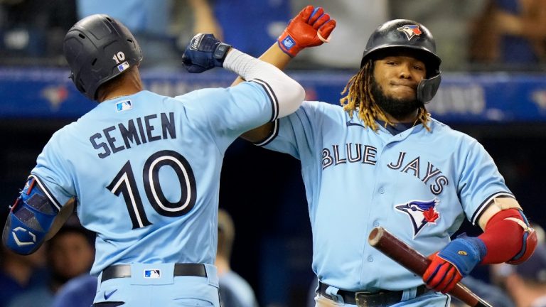 Toronto Blue Jays second baseman Marcus Semien (10) celebrates his solo home run with teammate Vladimir Guerrero Jr. (27) during fifth inning MLB baseball action against the Baltimore Orioles, in Toronto, Sunday, Oct. 3, 2021 (Frank Gunn/CP).