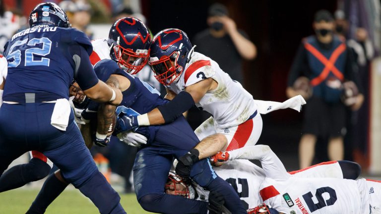Toronto Argonauts running back D.J. Foster (29) is brought down by defenders during second half CFL football action against the Montreal Alouettes. (Cole Burston/CP)