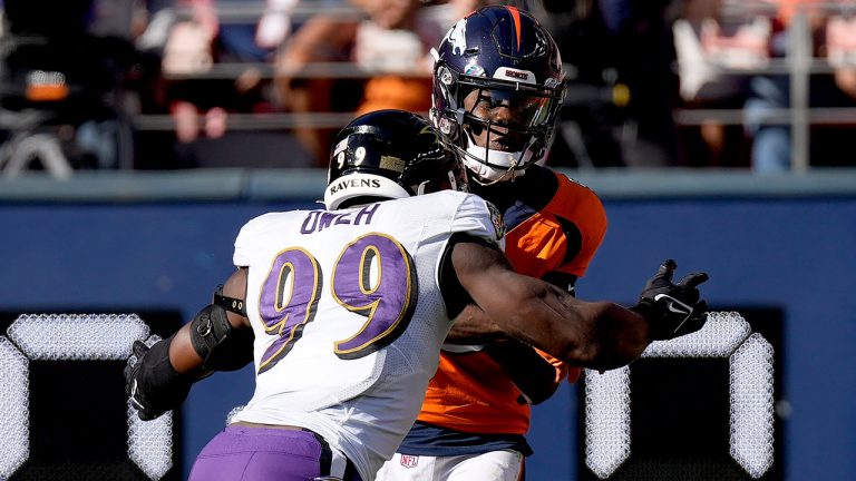 Denver Broncos quarterback Teddy Bridgewater is hit by Baltimore Ravens linebacker Odafe Oweh (99) during the first half of an NFL football game. (David Zalubowski/AP)