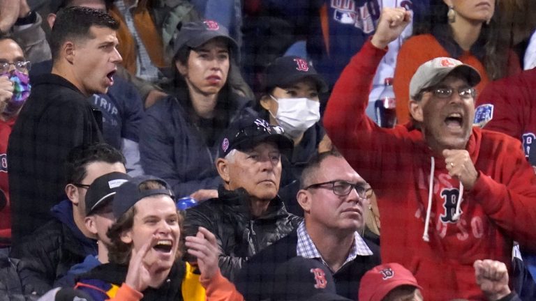 Former New York Yankees Bucky Dent (middle in Yankees cap) watches as Boston Red Sox fans cheer after Yankees' Brett Gardner struck out in the seventh inning of the American League Wild Card playoff game against the Boston Red Sox at Fenway Park, Tuesday Oct. 5, 2021 in Boston. (Charles Krupa/AP Photo)