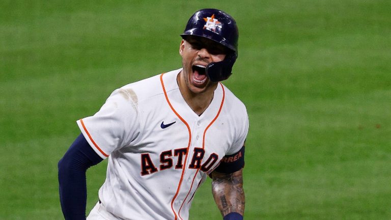 Houston Astros' Carlos Correa screams toward his dugout after hitting a go-ahead solo home run off Boston Red Sox relief pitcher Hansel Robles in the bottom of the seventh inning of Game 1 of baseball's American League Championship Series Friday, Oct. 15, 2021, in Houston. (Kevin M. Cox/The Galveston County Daily News via AP)