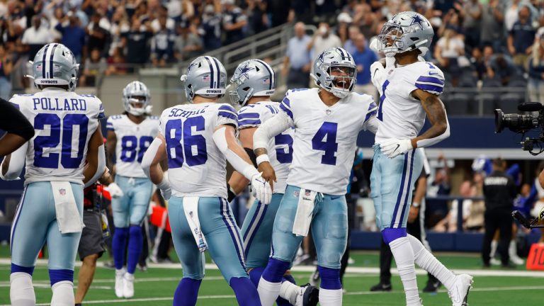 Dallas Cowboys' Tony Pollard (20), Dalton Schultz (86), Dak Prescott (4) and Cedrick Wilson (1) celebrate a touchdown catch made by Wilson in the second half of an NFL football game against the Carolina Panthers. (Michael Ainsworth/AP)