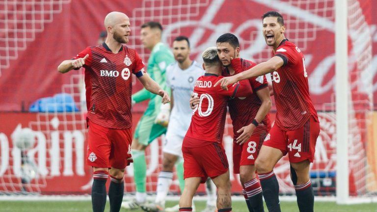 Toronto FC midfielder Marco Delgado (8) celebrates his goal with teammates Yeferson Soteldo (30), Michael Bradley (4) and Omar Gonzalez (44) during first half MLS soccer action against the Chicago Fire, in Toronto, Sunday, Oct. 3, 2021. (Cole Burston/AP)