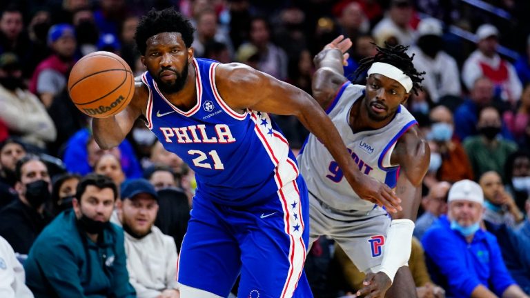 Philadelphia 76ers' Joel Embiid, left, dribbles past Detroit Pistons' Jerami Grant during the second half of an NBA basketball game, Thursday, Oct. 28, 2021, in Philadelphia. (Matt Slocum/AP)