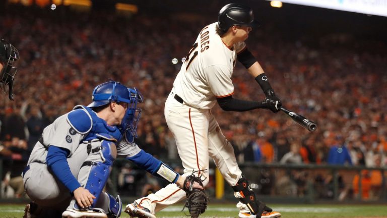 San Francisco Giants' Wilmer Flores, right, is called out swinging in front of Los Angeles Dodgers catcher Will Smith for the final out of the ninth inning of Game 5 of a baseball National League Division Series Thursday, Oct. 14, 2021, in San Francisco. (Jed Jacobsohn/AP Photo)