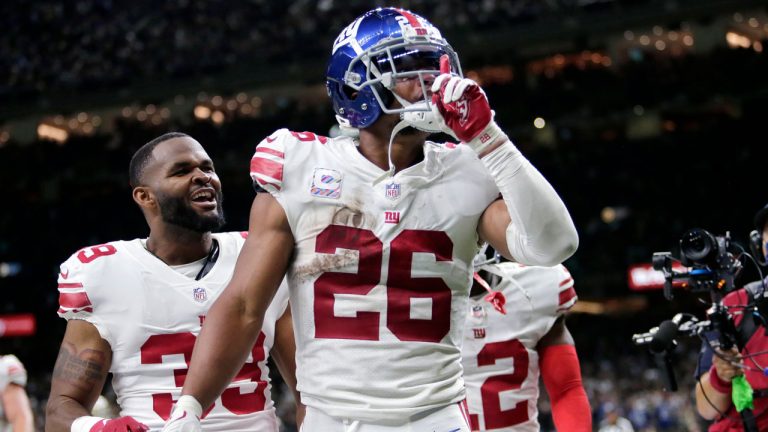 New York Giants running back Saquon Barkley (26) celebrates his touchdown in overtime to defeat the New Orleans Saints in an NFL football game in New Orleans. (Brett Duke/AP) 