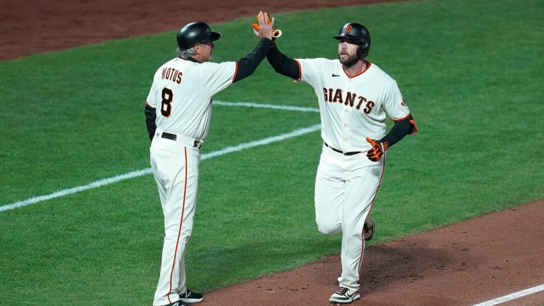 San Francisco Giants' Darin Ruf, right, is congratulated by third base coach Ron Wotus after hitting a home run against the Los Angeles Dodgers during the sixth inning of Game 5 of a baseball National League Division Series. (Eric Risberg/AP)