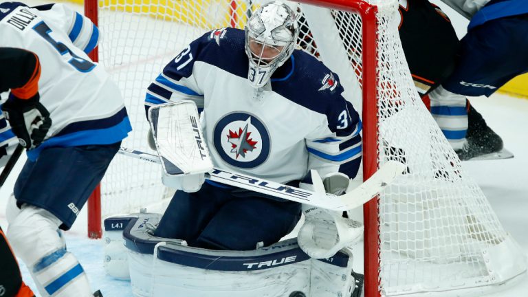 Winnipeg Jets goaltender Connor Hellebuyck makes a pad save against the Anaheim Ducks during the third period of an NHL hockey game in Anaheim, Calif., Wednesday, Oct. 13, 2021. (Alex Gallardo/AP)