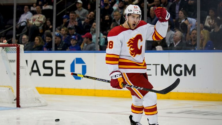 Calgary Flames left wing Andrew Mangiapane (88) reacts after scoring against New York Rangers goaltender Igor Shesterkin during the second period of an NHL hockey game. (John Minchillo/AP)