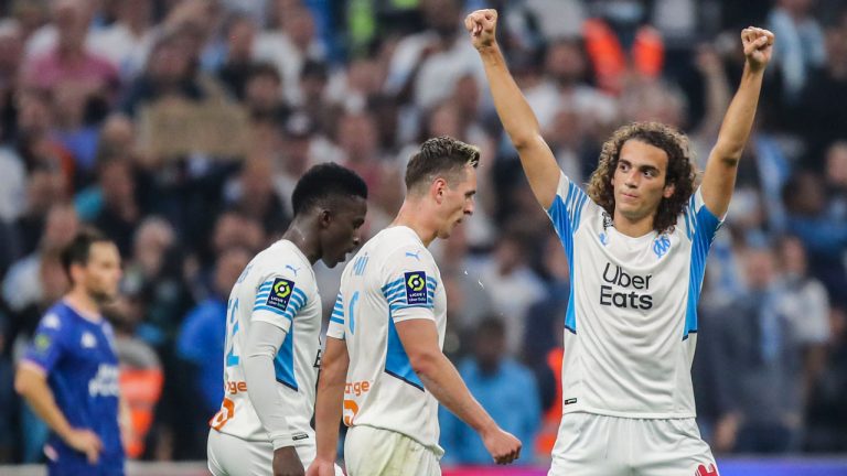 Marseille's Matteo Guendouzi, right, celebrates after scoring his side's fourth goal during the French League One soccer match between Marseille and FC Lorient at the Velodrome stadium. (Daniel Cole/AP)