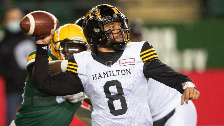 Hamilton Tiger-Cats quarterback Jeremiah Masoli (8) makes the throw against the Edmonton Elks during first half CFL action in Edmonton, Alta., on Friday October 29, 2021. (Jason Franson/CP)