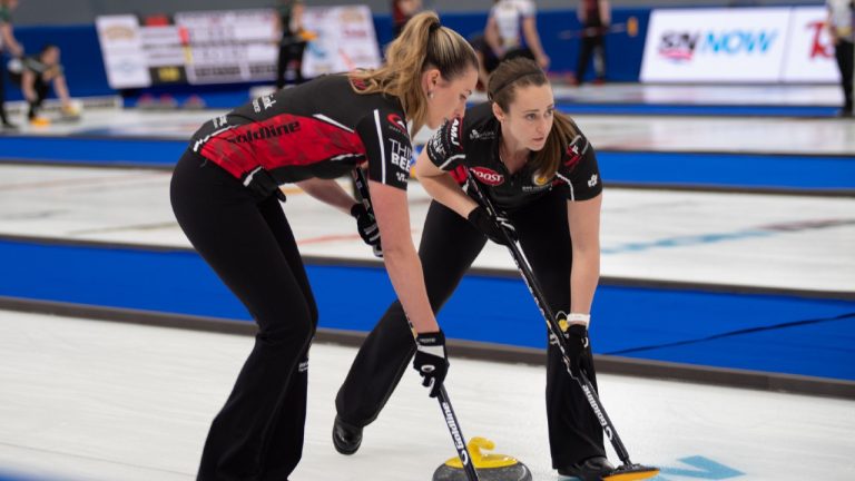 Team Homan third Emma Miskew (left) and lead Joanne Courtney (right) prepare to sweep a stone during the 2021 Champions Cup in Calgary. (Mike Cleasby)