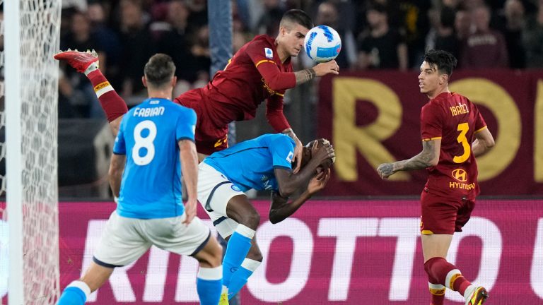 Roma's Gianluca Mancini, top, and Napoli's Victor Osimhen jump for the ball during a Serie A soccer match between Roma and Napoli, at Rome's Olympic Stadium. (Andrew Medichini/AP) 