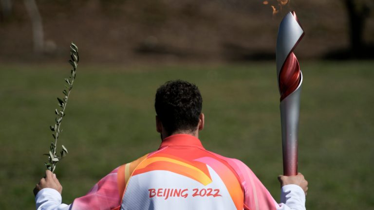 The first torch bearer, Greek alpine ski racer Ioannis Antoniou, runs after the lighting of the Olympic flame at Ancient Olympia site, birthplace of the ancient Olympics in southwestern Greece, Monday, Oct. 18, 2021. The flame will be transported by torch relay to Beijing, China, which will host the Feb. 4-20, 2022 Winter Olympics. (Petros Giannakouris/AP) 