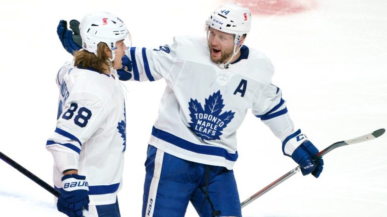 Toronto Maple Leafs' Morgan Rielly, right, congratulates teammate William Nylander following a goal during second period NHL Stanley Cup playoff hockey action against the Montreal Canadiens, in Montreal, Monday, May 24, 2021. (Paul Chiasson/CP)