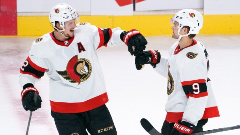 Ottawa Senators' Thomas Chabot, left, congratulates teammate Josh Norris after scoring the winning goal past Montreal Canadiens goaltender Jake Allen during a shootout. (Paul Chiasson/CP)

